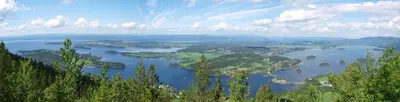 a view of a lake with trees and a city at Topcamp Onsakervika - Tyrifjorden in Svensrud