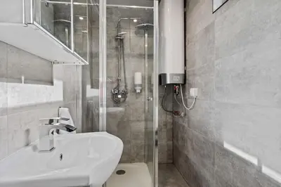 a bathroom with a shower and a toilet and a sink at Topcamp Onsakervika - Tyrifjorden in Svensrud
