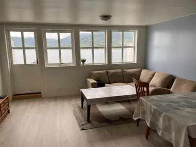 a living room with a couch and a table at Fjord Apartments in Dimmelsvik