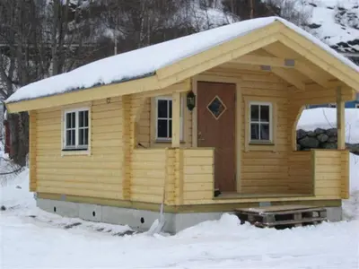 a wooden cabin with snow on top of it at Seim Camping - Røldal in Røldal
