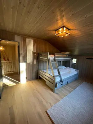 a bedroom with a bed in a wooden room at Geilo - Ny og flott hytte på budalstølen in Geilo