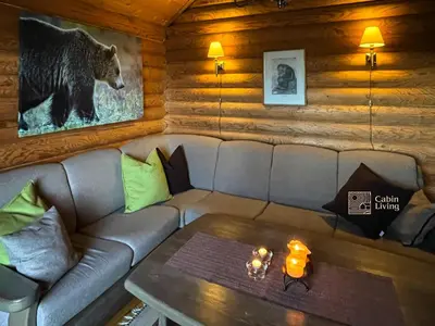 a living room with a couch and a table at Cozy cottage in central Beitostølen with Sauna in Beitostøl