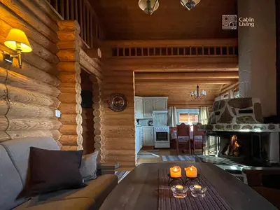 a living room with a table in a log cabin at Cozy cottage in central Beitostølen with Sauna in Beitostøl