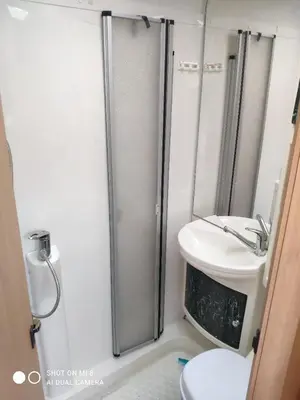 a bathroom with a shower and a toilet and a sink at Airbnb and Booking at Postvegen 95 in Vigra