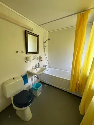 a bathroom with a toilet and a sink and a tub at Hallingskarvet Fjellstue as in Hovet