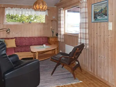 a living room with a couch and a table at 6 person holiday home in VATNE-By Traum in Vatne