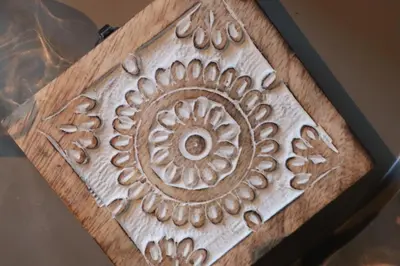 a wooden box with a carving of a flower on it at Cozy Apartment by the slopes in Kvitfjell Vest in Favang