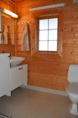 a bathroom with a toilet and a sink and a window at Uvdalhytta - close to cross country and downhill skiing in Uvdal