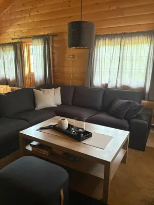 a living room with a couch and a coffee table at Uvdalhytta - close to cross country and downhill skiing in Uvdal