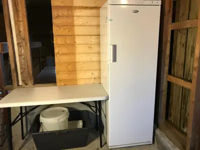 a white refrigerator in a room with a toilet at Seaside 3-bedroom House in Svelgen