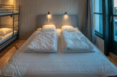 a large bed in a bedroom with two bunk beds at Bakkebyvegen 22B in Trysil