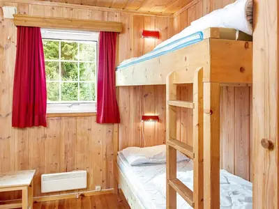a bedroom with two bunk beds and a window at 7 person holiday home in Hemsedal-By Traum in Hemsedal