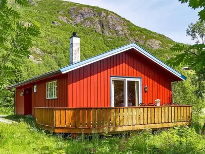 a red cabin with a hill in the background at 7 person holiday home in Hemsedal-By Traum in Hemsedal