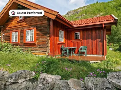 a log cabin with two chairs in front of it at 5 person holiday home in Hemsedal-By Traum in Hemsedal