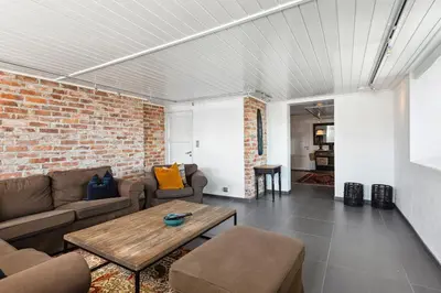 a living room with a couch and a table at Solsiden - in the center of Geilo in Geilo