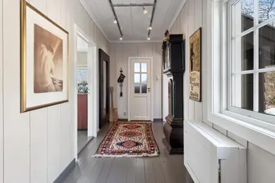 a hallway with a door and a rug at Solsiden - in the center of Geilo in Geilo