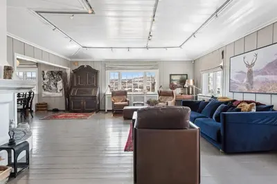 a living room with a blue couch and chairs at Solsiden - in the center of Geilo in Geilo