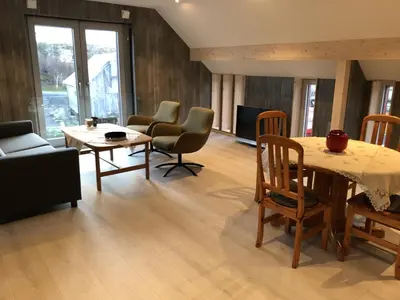 a living room with a table and chairs at Robinsons Rorbu - located in Bud in Bud