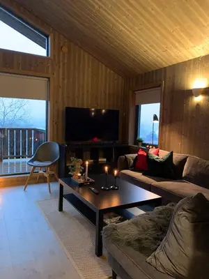 a living room with a couch and a coffee table at Cozy Apartment electric car charger & ski in out Sjusjøen in Sjusjøen