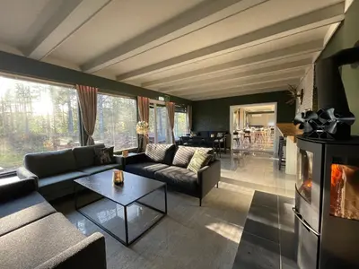a living room with a couch and a fireplace at Fossanåsen Hotel in Flesberg