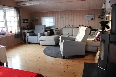 a living room with couches and chairs in a room at Hytte sentralt Ljøsheim, Ringsaker(nær Sjusjøen) in Ringsaker