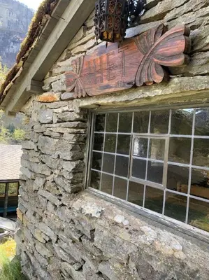 a stone building with a window on the side of it at Voss/Bolstad: Peaceful countryside cabin/lodge in Bolstadøyri