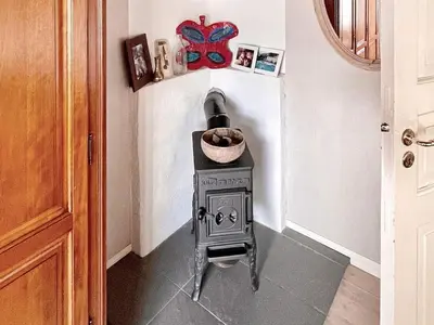a stove in the corner of a room at 8 person holiday home in MÅLØY-By Traum in Måløy