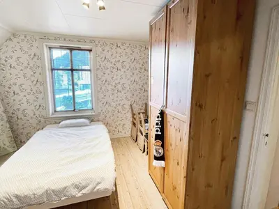 a small bedroom with a bed and a window at 8 person holiday home in MÅLØY-By Traum in Måløy