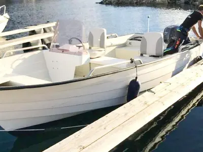 a white boat is docked at a dock at 8 person holiday home in MÅLØY-By Traum in Måløy