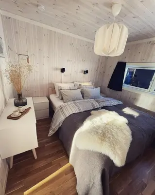 a bedroom with a large bed and a table at Skarvebo - cabin with amazing view in Hol