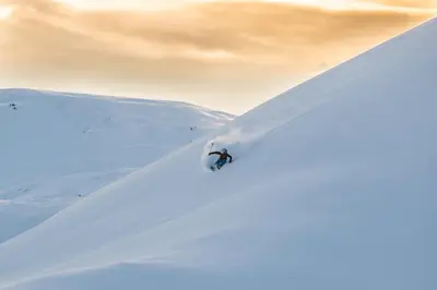 a person is skiing down a snow covered slope at Panorama 17 - fantastisk utsikt! in Sogndal