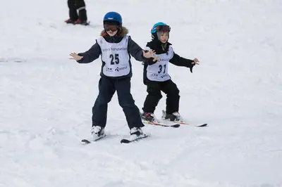 two children are standing in the snow on skis at Panorama 17 - fantastisk utsikt! in Sogndal