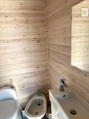 a bathroom with a toilet and a sink at Bergen/Sotra: Sea cabin. Spa. Fishing. Boat in Haganes