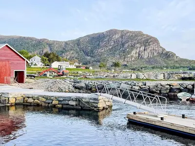 a bridge over a body of water with a mountain at 5 person holiday home in Svelgen-By Traum in Svelgen