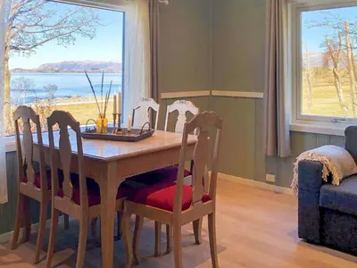 a dining room with a table and chairs and a window at 5 person holiday home in Svelgen-By Traum in Svelgen