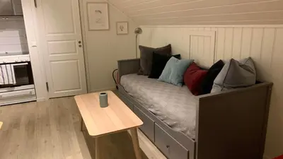 a small room with a bed and a table at Bright and cozy apartment 1.5km from city centre in Aurland