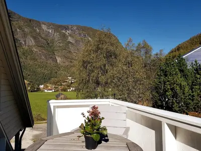 a potted plant sitting on a table on a balcony at Bright and cozy apartment 1.5km from city centre in Aurland