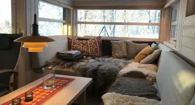 a living room with a couch and a table at Venehovda - cabin at 1000 masl in Ål