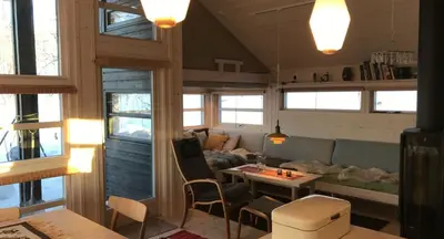 a living room with a couch and a table at Venehovda - cabin at 1000 masl in Ål