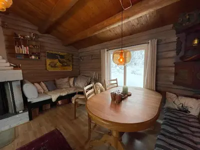 a living room with a wooden table and a couch at Buhaug - cabin at Sjusjøen in Sjusjøen