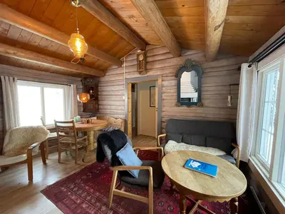 a living room with a couch and a table at Buhaug - cabin at Sjusjøen in Sjusjøen