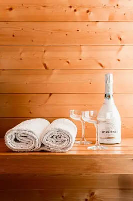 a bottle of wine and glasses on a wooden shelf at VILLA BRATTHOLMEN in Brattholmen