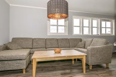 a living room with a couch and a coffee table at Skitorget Apartments in Trysil