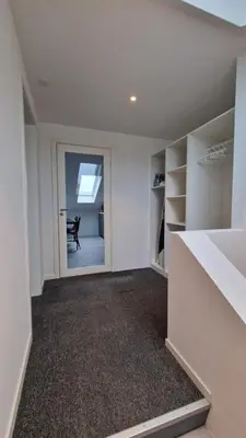 an empty room with a grand piano in a room at Lovely 2-bedroom loft with panoramic view. in Kristiansund