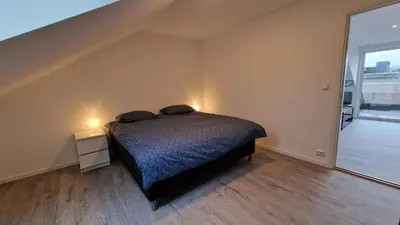 a bedroom with a bed with two pillows on it at Lovely 2-bedroom loft with panoramic view. in Kristiansund