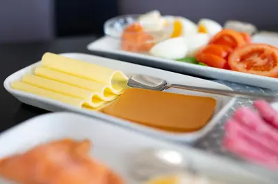 two trays of cheese and other food on a table at Sjøholt Sommerhotell in Ørskog