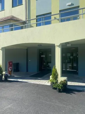 an entrance to a building with a parking lot at Sjøholt Sommerhotell in Ørskog
