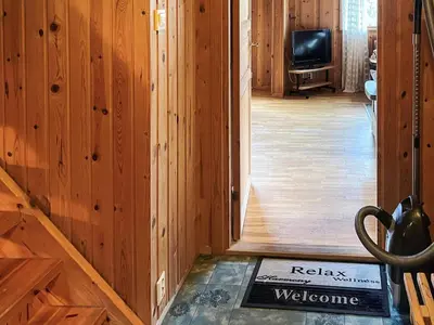 a hallway with a door to a room with a television at 7 person holiday home in STRYN-By Traum in Stryn