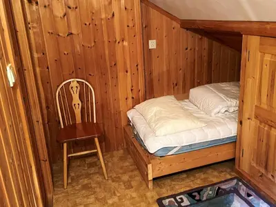 a small room with a bed and a chair at 7 person holiday home in STRYN-By Traum in Stryn
