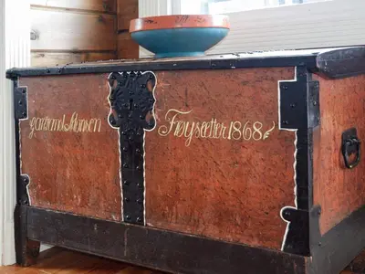 an old chest with a bowl on top of it at 4 person holiday home in Utvik-By Traum in Utvik